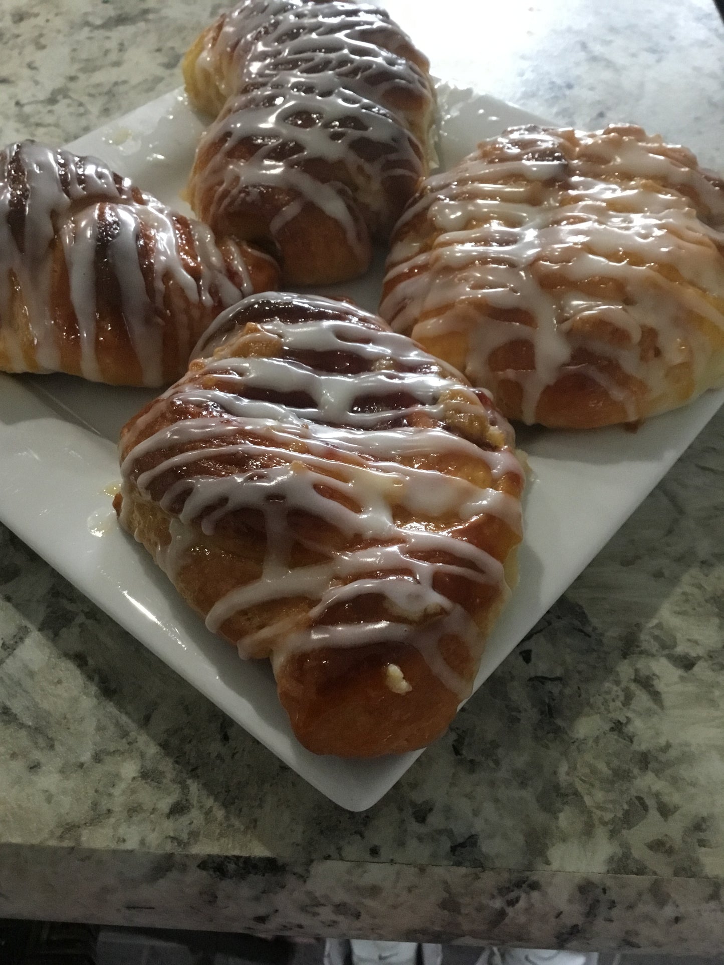 Duchess Danisha Old World Danish pastry from Bella Dolce Bakery with flaky golden layers and sweet filling on a white plate.