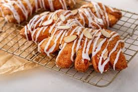 Bella Dolce Bakery Beary Fierce Bear Claw pastry with flaky golden crust and sweet filling on a white plate.